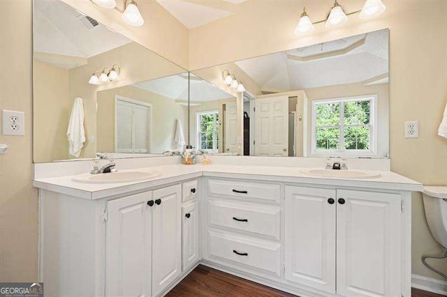 2004 Spicers Ln, Woodstock, GA 30189 - bathroom with double vanity, plenty of natural light, and wood finished floors