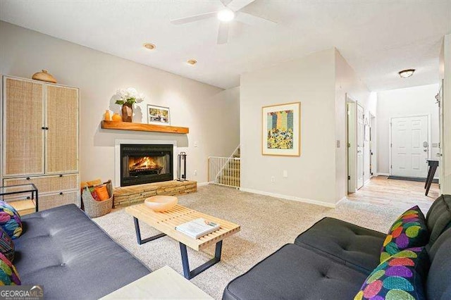 2004 Spicers Ln, Woodstock, GA 30189 - carpeted living room with a lit fireplace, ceiling fan, stairs, and baseboards