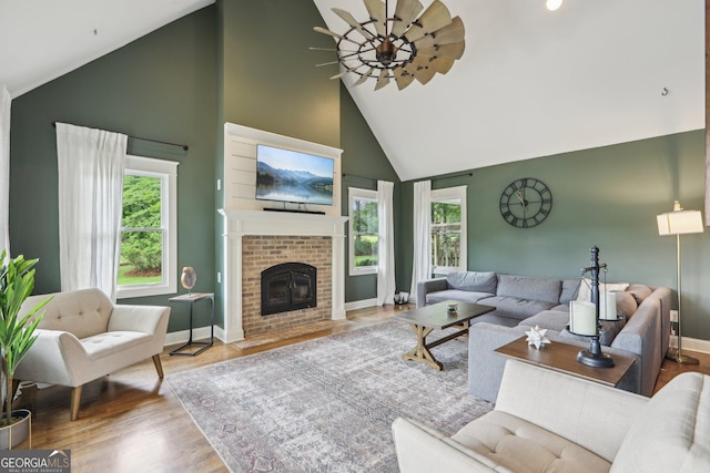 3612 Bill Gardner Pkwy, Locust Grove, GA 30248 - living room featuring high vaulted ceiling, wood finished floors, baseboards, and a brick fireplace