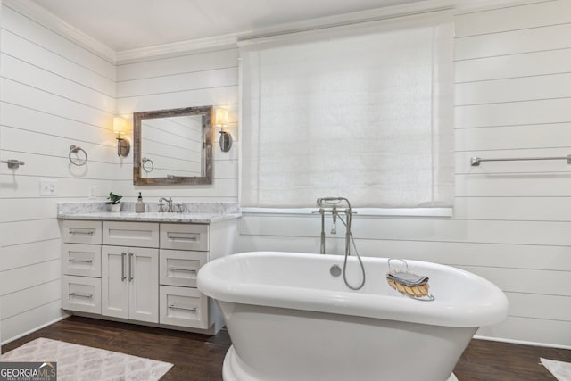 3612 Bill Gardner Pkwy, Locust Grove, GA 30248 - bathroom with vanity, wood walls, a freestanding bath, wood finished floors, and ornamental molding