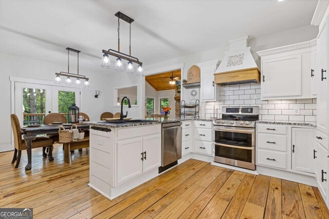 6224 Eagle Ct, Gainesville, GA 30506 - kitchen featuring stainless steel appliances, custom range hood, a peninsula, a ceiling fan, and white cabinets