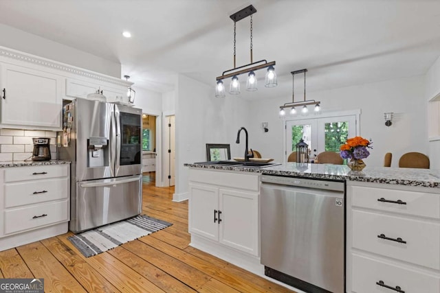 6224 Eagle Ct, Gainesville, GA 30506 - kitchen featuring stainless steel appliances, french doors, white cabinetry, light wood finished floors, and stone counters
