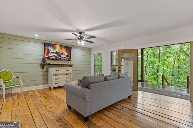 6224 Eagle Ct, Gainesville, GA 30506 - living room featuring hardwood / wood-style flooring, ceiling fan, and wooden walls