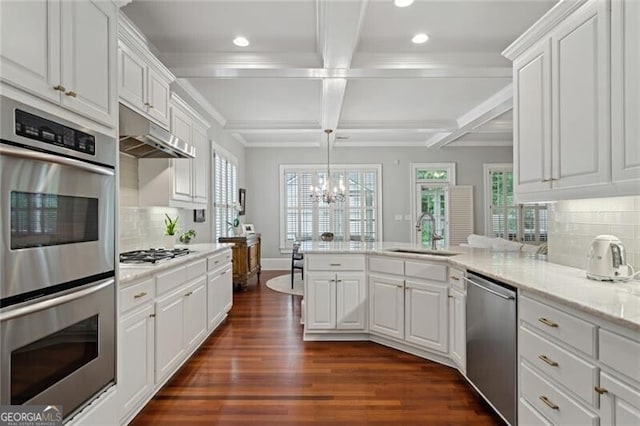 1070 Standard Dr NE, Brookhaven, GA 30319 - kitchen with stainless steel appliances, under cabinet range hood, a peninsula, coffered ceiling, and a chandelier