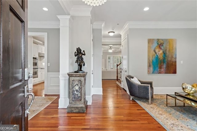 1070 Standard Dr NE, Brookhaven, GA 30319 - entrance foyer featuring ornate columns, ornamental molding, wood finished floors, stairs, and a ceiling fan