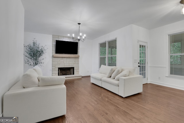 11280 Brookhollow Trl, Alpharetta, GA 30022 - living room with a chandelier, wood finished floors, healthy amount of natural light, and a fireplace