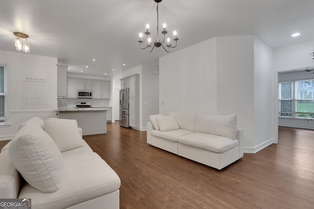 11280 Brookhollow Trl, Alpharetta, GA 30022 - living area with dark wood finished floors, a chandelier, and recessed lighting