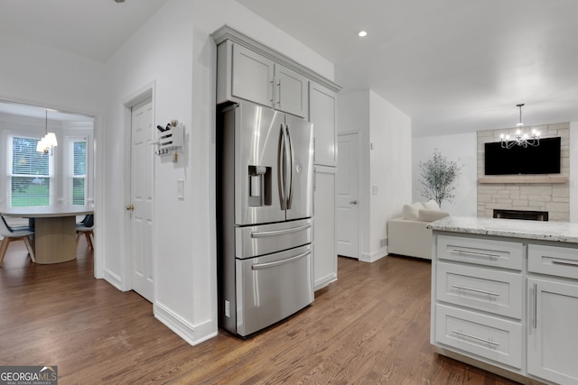 11280 Brookhollow Trl, Alpharetta, GA 30022 - kitchen with stainless steel fridge with ice dispenser, a chandelier, wood finished floors, gray cabinets, and open floor plan