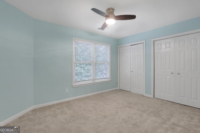 11280 Brookhollow Trl, Alpharetta, GA 30022 - unfurnished bedroom featuring carpet flooring, two closets, and a ceiling fan