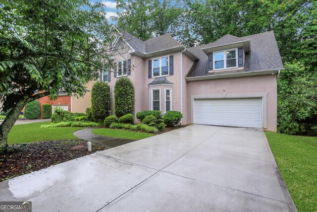 11280 Brookhollow Trl, Alpharetta, GA 30022 - view of front facade with concrete driveway, stucco siding, roof with shingles, and a front lawn