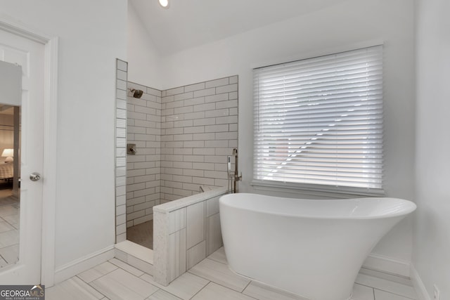 11280 Brookhollow Trl, Alpharetta, GA 30022 - bathroom with walk in shower, a freestanding tub, lofted ceiling, and tile patterned floors