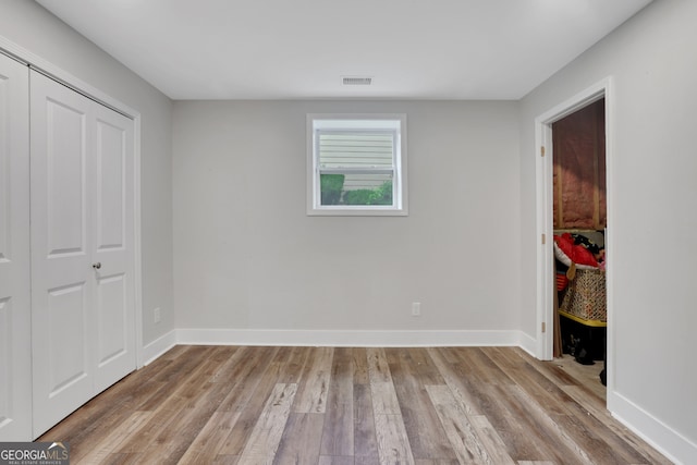 11280 Brookhollow Trl, Alpharetta, GA 30022 - unfurnished bedroom featuring light wood-style floors and a closet