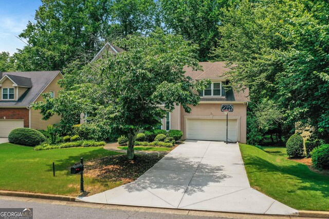 11280 Brookhollow Trl, Alpharetta, GA 30022 - obstructed view of property with driveway, a garage, a front yard, and stucco siding