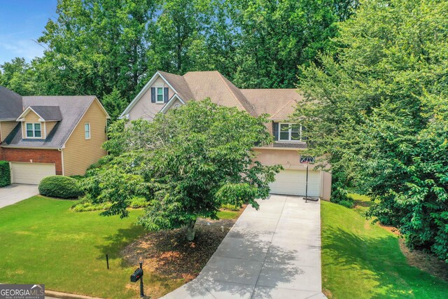 11280 Brookhollow Trl, Alpharetta, GA 30022 - view of front of home featuring a garage, driveway, a front yard, and stucco siding