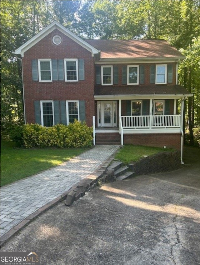 1970 Sturbridge Ln, Buford, GA 30519 - colonial-style house with a porch and a front lawn