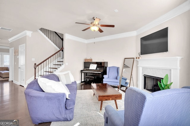 5910 Terrace Bend Way, Peachtree Corners, GA 30092 - living area featuring ornamental molding, ceiling fan, stairway, wood finished floors, and a fireplace