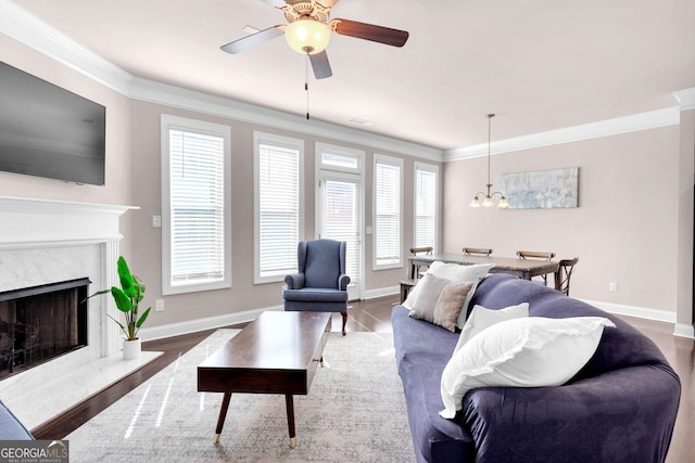 5910 Terrace Bend Way, Peachtree Corners, GA 30092 - living room featuring crown molding, a chandelier, ceiling fan, a high end fireplace, and wood finished floors