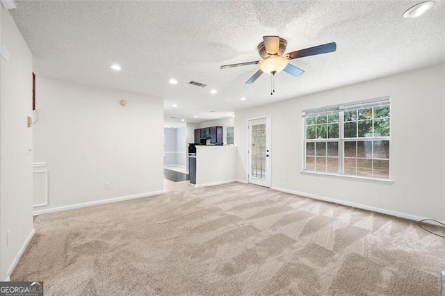 1486 Rogers Crossing Dr, Lithonia, GA 30058 - unfurnished living room featuring carpet, ceiling fan, a textured ceiling, and recessed lighting