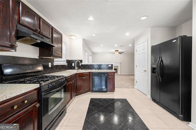1486 Rogers Crossing Dr, Lithonia, GA 30058 - kitchen with black appliances, under cabinet range hood, light countertops, decorative backsplash, and a peninsula