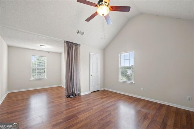 1486 Rogers Crossing Dr, Lithonia, GA 30058 - unfurnished bedroom with wood finished floors, vaulted ceiling, and a ceiling fan