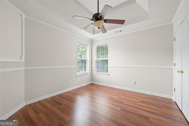 1486 Rogers Crossing Dr, Lithonia, GA 30058 - empty room with wood finished floors, a tray ceiling, crown molding, ceiling fan, and a textured ceiling