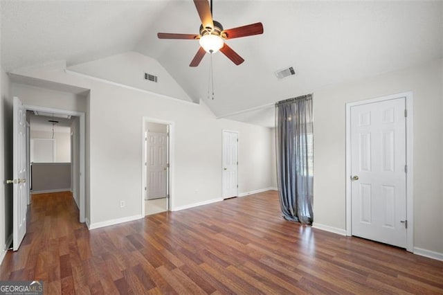 1486 Rogers Crossing Dr, Lithonia, GA 30058 - unfurnished bedroom with wood finished floors, vaulted ceiling, and ceiling fan