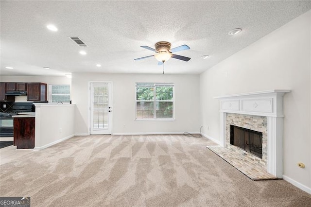 1486 Rogers Crossing Dr, Lithonia, GA 30058 - unfurnished living room featuring light carpet, ceiling fan, a textured ceiling, recessed lighting, and a fireplace