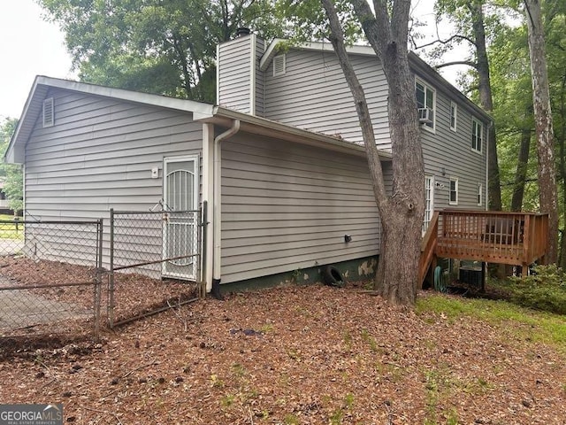 4514 Tifton Ct, Powder Springs, GA 30127 - view of home's exterior with a deck, a chimney, cooling unit, and a gate
