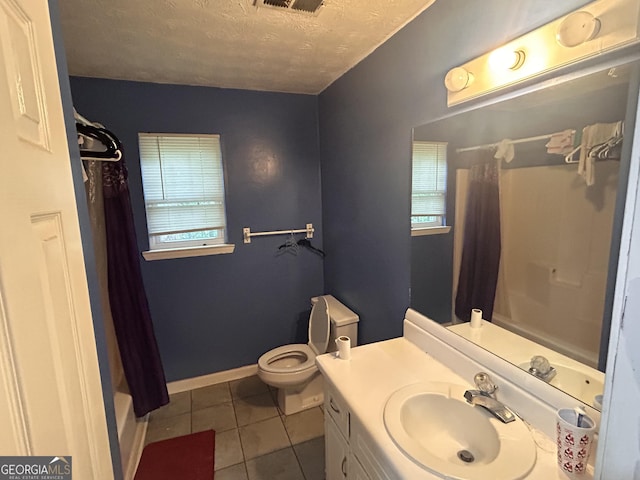 4514 Tifton Ct, Powder Springs, GA 30127 - full bath with tile patterned floors, vanity, shower / bath combo with shower curtain, a textured ceiling, and toilet