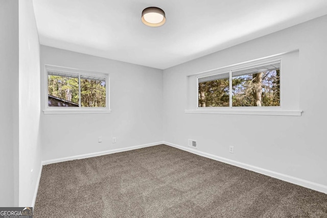 696 Kenilworth Cir, Stone Mountain, GA 30083 - carpeted empty room featuring baseboards and healthy amount of natural light