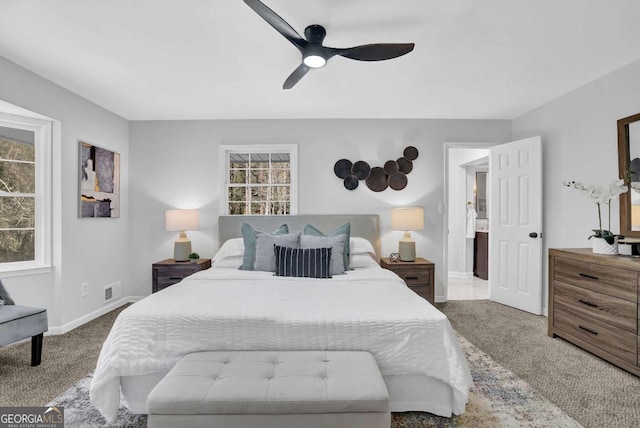 696 Kenilworth Cir, Stone Mountain, GA 30083 - carpeted bedroom featuring multiple windows, baseboards, and ceiling fan