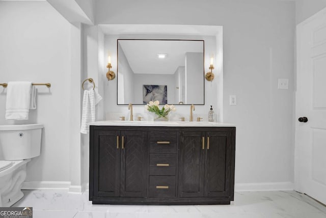 696 Kenilworth Cir, Stone Mountain, GA 30083 - bathroom with marble look tiles, baseboards, double vanity, and toilet