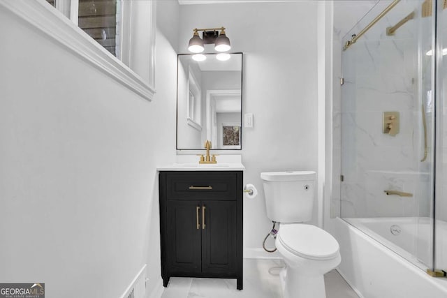 696 Kenilworth Cir, Stone Mountain, GA 30083 - bathroom featuring toilet, vanity, combined bath / shower with glass door, and baseboards