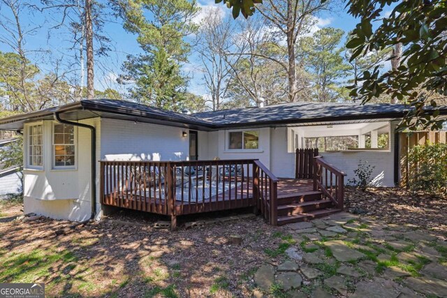 696 Kenilworth Cir, Stone Mountain, GA 30083 - back of house with brick siding and a deck