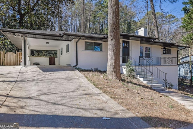 696 Kenilworth Cir, Stone Mountain, GA 30083 - view of front of home featuring asphalt driveway, a carport, and a chimney