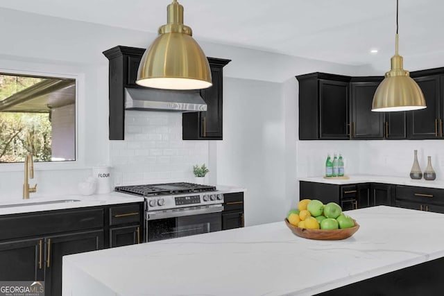 696 Kenilworth Cir, Stone Mountain, GA 30083 - kitchen with stainless steel gas stove, a sink, dark cabinetry, tasteful backsplash, and recessed lighting