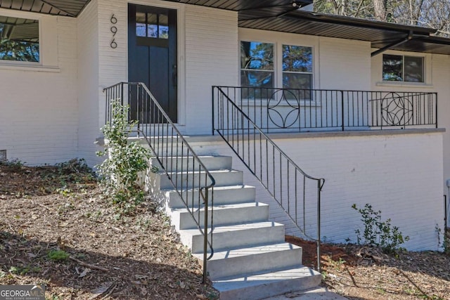696 Kenilworth Cir, Stone Mountain, GA 30083 - doorway to property with brick siding and covered porch