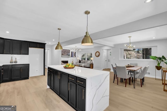 696 Kenilworth Cir, Stone Mountain, GA 30083 - kitchen featuring a chandelier, dark cabinetry, light wood-style floors, recessed lighting, and decorative light fixtures