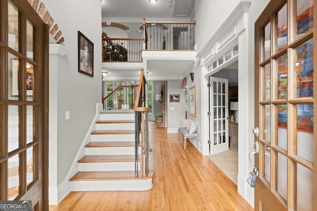 979 Pathview Ct, Dacula, GA 30019 - entrance foyer featuring a high ceiling, french doors, crown molding, light wood-style flooring, and stairs