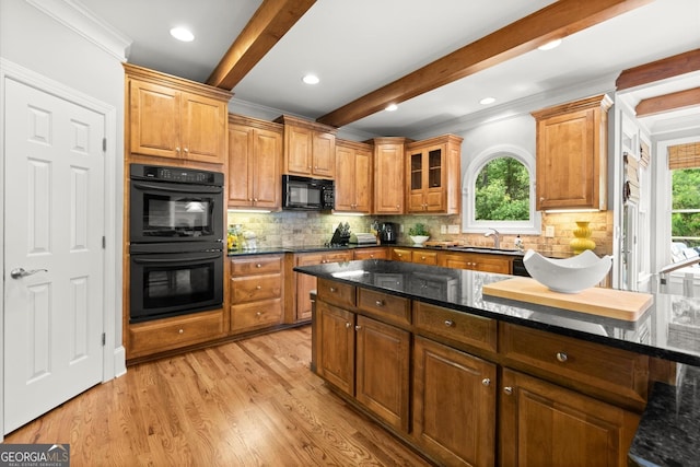 979 Pathview Ct, Dacula, GA 30019 - kitchen with black appliances, a sink, beam ceiling, plenty of natural light, and dark stone countertops