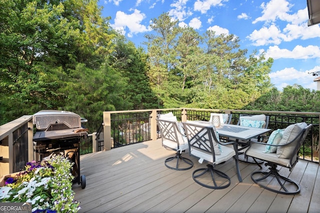 979 Pathview Ct, Dacula, GA 30019 - wooden deck with outdoor dining space, grilling area, and a wooded view