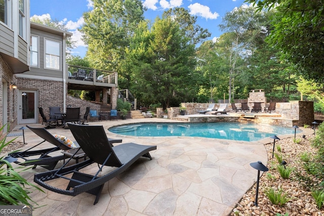 979 Pathview Ct, Dacula, GA 30019 - view of pool featuring a stone fireplace, a patio area, stairway, and view of scattered trees