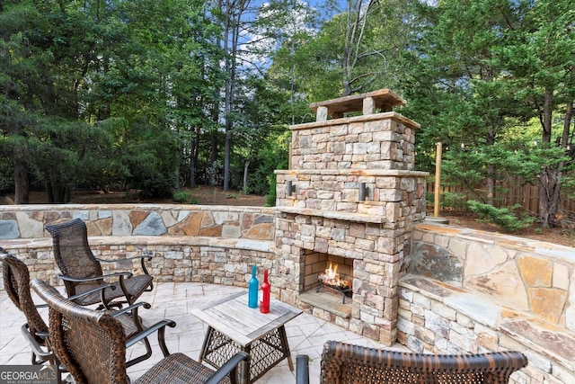979 Pathview Ct, Dacula, GA 30019 - view of patio featuring an outdoor stone fireplace and view of wooded area