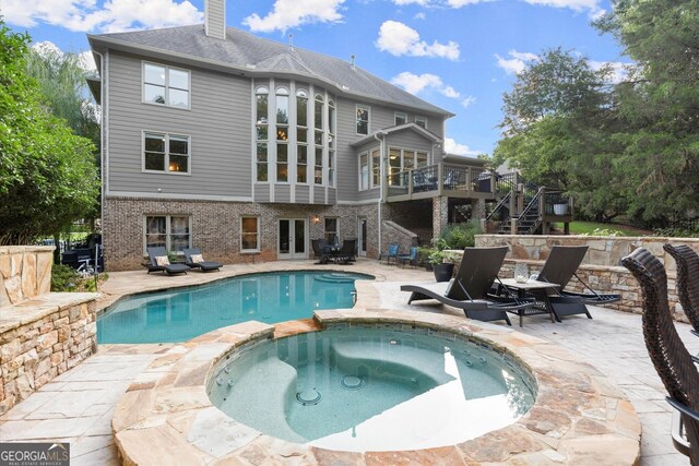979 Pathview Ct, Dacula, GA 30019 - view of swimming pool with a patio, stairs, and a pool with connected hot tub