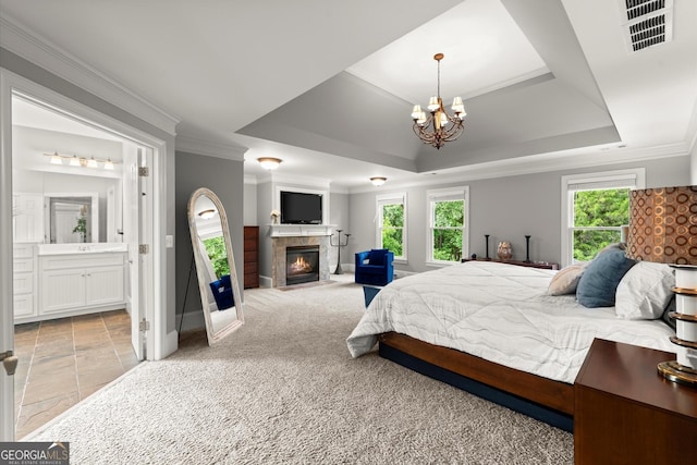 979 Pathview Ct, Dacula, GA 30019 - bedroom featuring a chandelier, crown molding, a tiled fireplace, baseboards, and ensuite bath