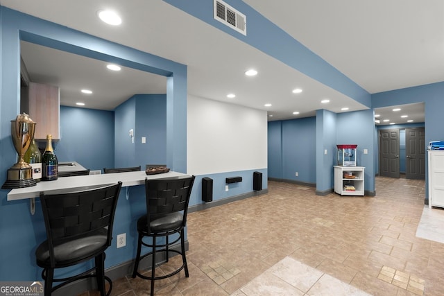 979 Pathview Ct, Dacula, GA 30019 - kitchen featuring recessed lighting, a kitchen breakfast bar, a peninsula, baseboards, and light countertops