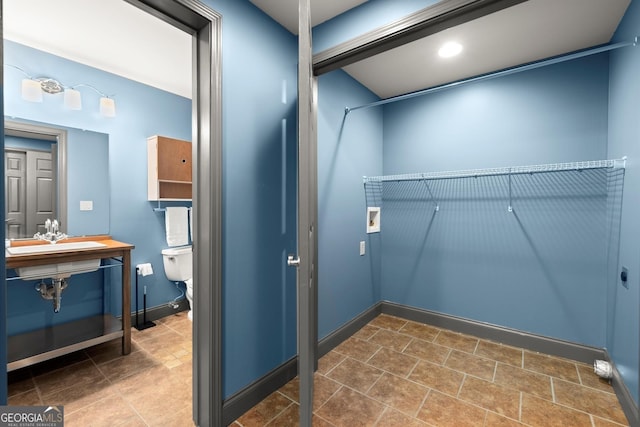 979 Pathview Ct, Dacula, GA 30019 - laundry area featuring a sink, baseboards, and stone finish floors