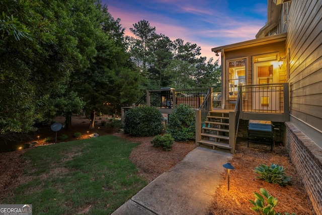 979 Pathview Ct, Dacula, GA 30019 - yard at dusk featuring a deck, a yard, and stairs