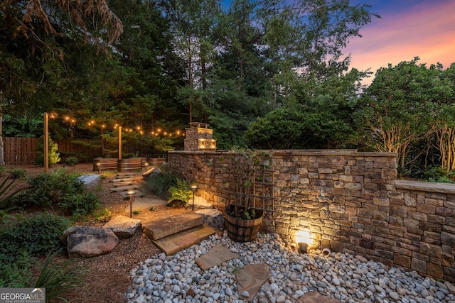 979 Pathview Ct, Dacula, GA 30019 - yard at dusk with an outdoor stone fireplace