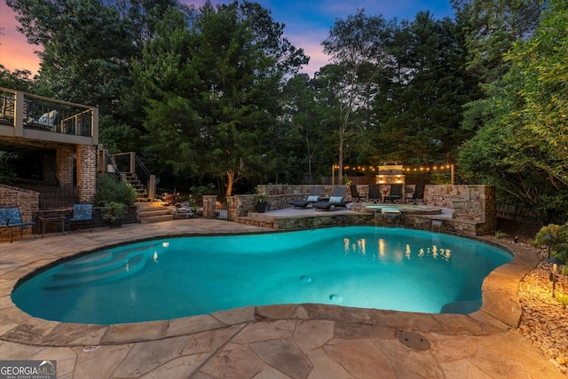 979 Pathview Ct, Dacula, GA 30019 - pool at dusk featuring an in-ground hot tub, stairway, and a patio